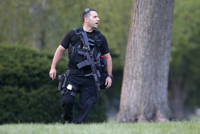 A member of the U.S. Secret Service Emergency Response Team (ERT) stands watch on the North Lawn at the White House in Washington, Thursday, Aug. 7, 2014. It’s usually someone jumping over the White House fence that causes Secret Service agents patrolling the grounds to scramble. 