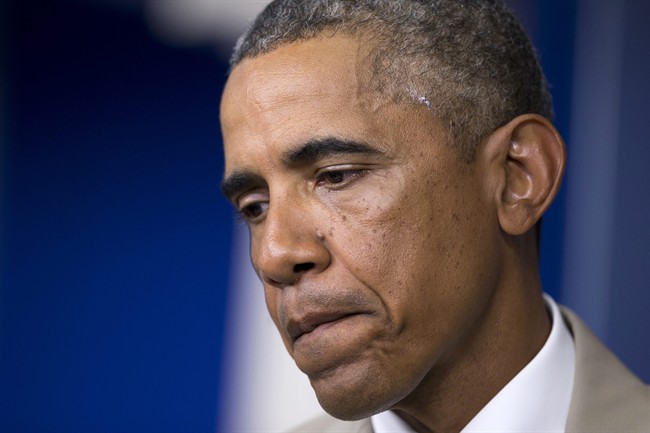 President Barack Obama pauses while speaking about the economy, Iraq, and Ukraine, Thursday, Aug. 28, 2014, in the James Brady Press Briefing Room of the White House in Washington. 