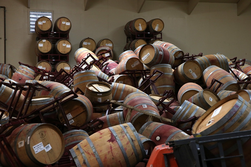 A mound of toppled wine barrels sit in a storage room at Kieu Hoang Winery on August 25, 2014 in Napa, California. A day after a 6.0 earthquake rocked the Napa Valley, residents and wineries are continuing clean up operations. (Photo by Justin Sullivan/Getty Images).