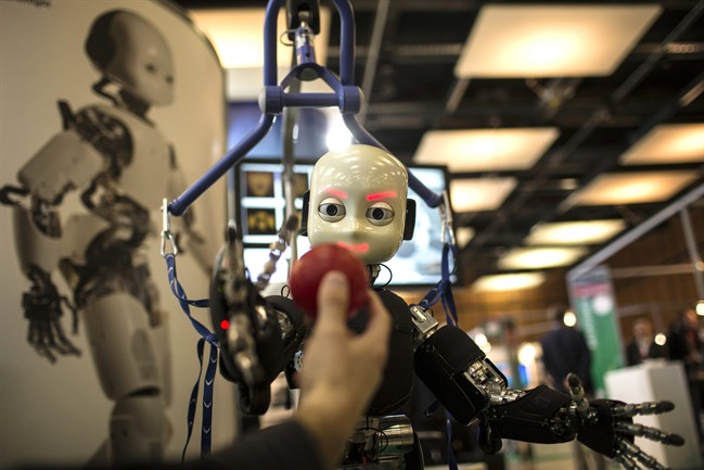 The iCub robot tries to catch a ball during the Innorobo European summit, an event dedicated to the service robotics industry, in France. Robots and artificial intelligence could create a near-dystopian income gap, kill all low-skill jobs, or have little impact over the next decade, according to a new survey.