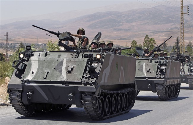 Lebanese army reinforcements arrive to the outskirts of Arsal, a predominantly Sunni Muslim town near the Syrian border in eastern Lebanon, Monday, Aug. 4, 2014.
