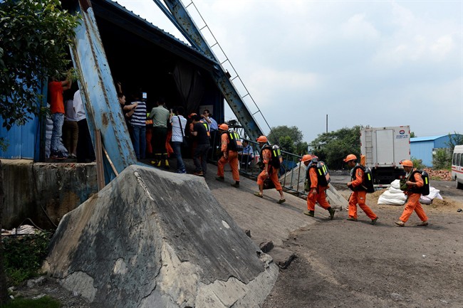 In this Aug. 19, 2014 photo, rescuers prepare to go into the Dongfang Coal Mine in Xiejiaji District of Huainan City, east China's Anhui Province, Tuesday, Aug. 19, 2014.