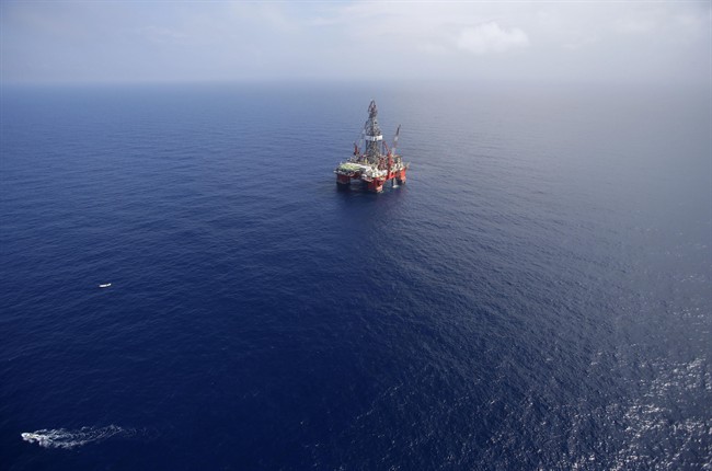 FILE - In this Nov. 22, 2013, file photo, the Centenario deep-water drilling platform stands off the coast of Veracruz, Mexico. (AP Photo/Dario Lopez-Mills, File).