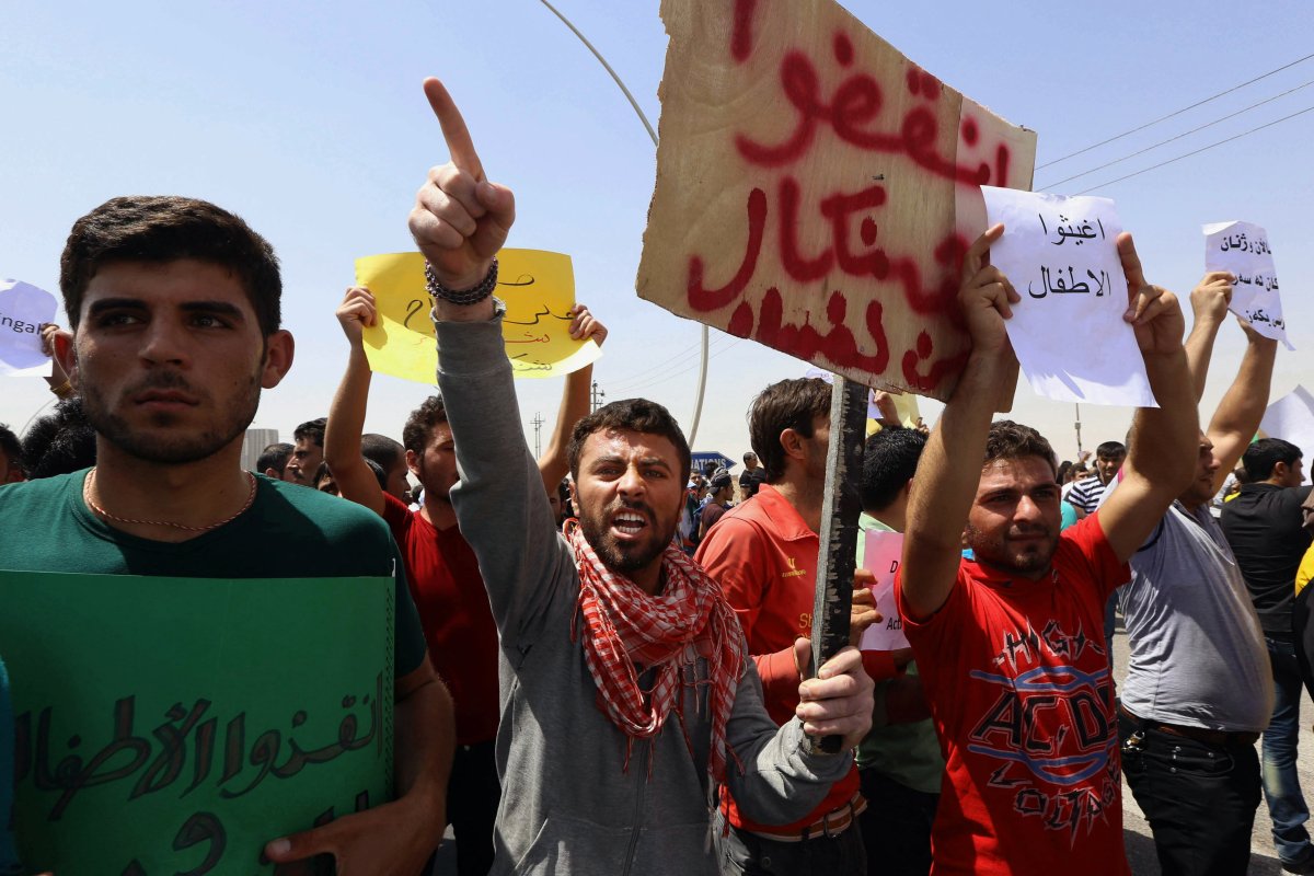 Iraqis from the Yazidi community chant anti Islamic militants slogans in front of UN headquarters to ask for international protection in Irbil, Iraq, Monday, Aug. 4, 2014. (AP Photo).