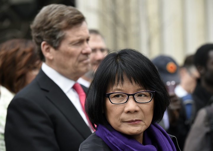 Toronto mayoral candidates John Tory (LEFT) and Olivia Chow, attend a flag raising ceremony at city hall on May 16 2014.