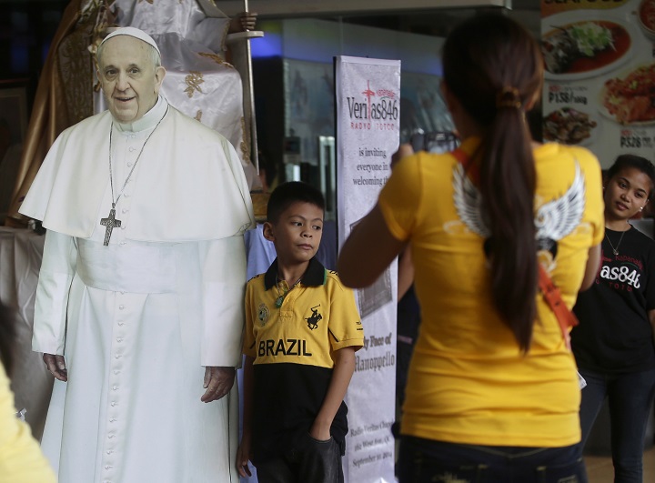 Filipinos have their photos taken with a cutout of Pope Francis at Mall of Asia, the country's largest shopping mall, Wednesday, Sept. 10, 2014 at suburban Pasay city, south of Manila, Philippines. In Asia's bastion of Roman Catholic faith, images of Pope Francis are getting the K-pop treatment. Life-size cardboard cutouts are being distributed to churches, schools and malls in the Philippine capital to generate "papal fever" before the pope's visit. 