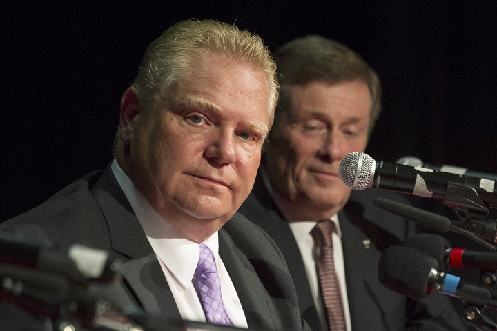 Doug Ford (left) sits alongside John Tory as he takes part in a Toronto Mayoral Debate, in Toronto on Tuesday, September 23, 2014. The debate represented his first appearance with other candidates since his belated entry into the race following the last minute withdrawal by his brother and incumbent Mayor Rob Ford for health reasons. THE CANADIAN PRESS/Chris Young.