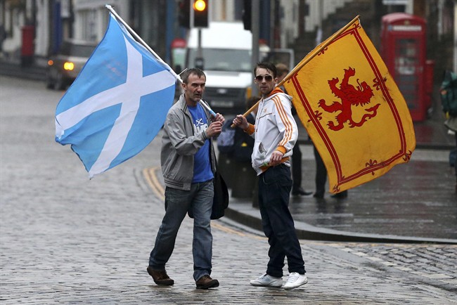 Supporters of the Yes campaign for the Scottish independence referendum stand on the Royal Mile in Edinburgh, Scotland, Friday, Sept. 19, 2014. THE CANADIAN PRESS/AP, Scott Heppell.