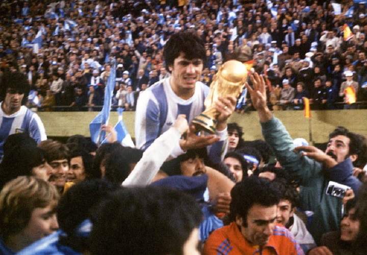Argentine’s national soccer team captain Daniel Passarella holds the World Cup trophy as he is carried on the shoulders of fans after Argentina defeated the Netherlands 3-1 in extra time, 25 June 1978 in Buenos Aires, during the World Cup soccer final.