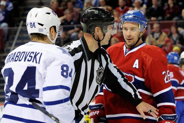 NHL linesman Brian Murphy #93 separates Josh Gorges #26 of the Montreal Canadiens and Mikhail Grabovski #84 of the Toronto Maple Leafs after a play stoppage during the NHL game at the Bell Centre