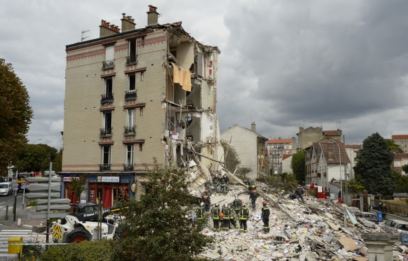 Firefighters search through the rubble of a four-storey residential building that collapsed following a blast in Rosny-sous-Bois in the eastern suburbs of Paris on August 31, 2014. A four-storey residential building collapsed in a Paris suburb following an explosion possibly due to a gas leak, killing at least one child and an elderly woman, local emergency services said. Ten people were also wounded, including four in serious condition, while 11 others are still unaccounted for. 