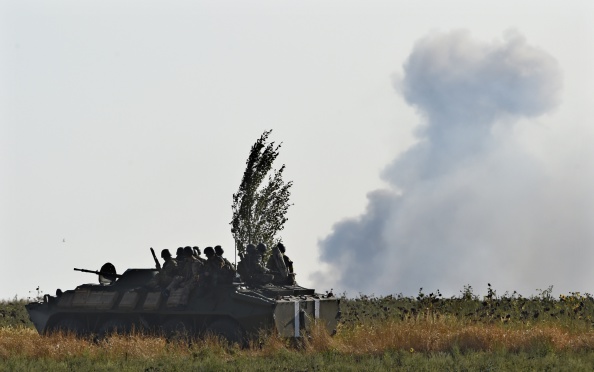 A Ukrainian army vehicle drives  as pro-Russian separatists fire heavy artillery, on the outskirts of the key southeastern port city of Mariupol, on September 5, 2014.  NATO leaders are expected to announce a raft of fresh sanctions against Russia on Friday over its actions in Ukraine, although hopes remain that a ceasefire can be forged at peace talks in Minsk on the same day.