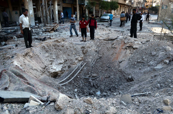 A big hole is occurred after the attacks of Syrian regime forces with warcrafts in the Duma neighbourhood of Damascus that is controlled by opposition forces, Syria on 16 September, 2014.