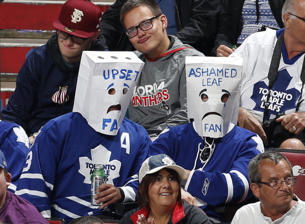 Two Toronto Maple Leafs fans wearing paper bags over their heads watch third period action against the Florida Panthers at the BB&amp;T Center on April 10, 2014 in Sunrise, Florida.