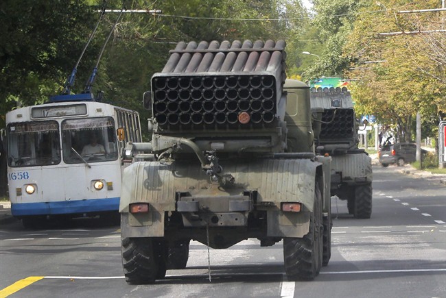 Pro-Russian rebels drive multiple rocket launchers "Grad" (means "hail") in the town of Donetsk, eastern Ukraine, Thursday, Sept. 11, 2014.