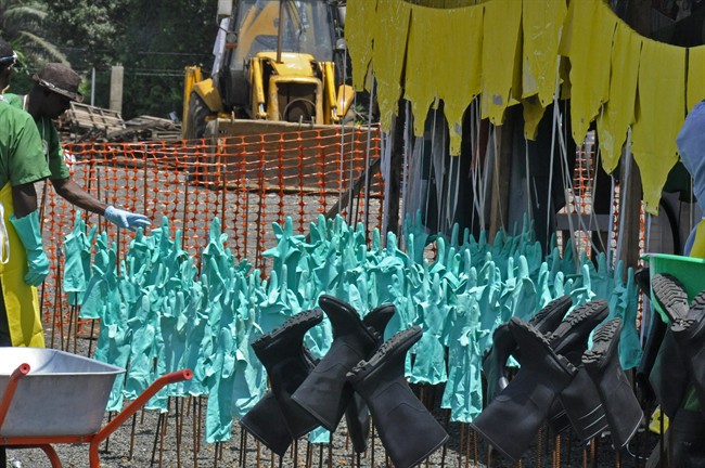 Gloves and rubber boots forming part of the Ebola prevention gear for health workers at a clinic are set outside for the sun to dry them after being washed in Monrovia, Liberia, Monday, Sept. 8, 2014. 