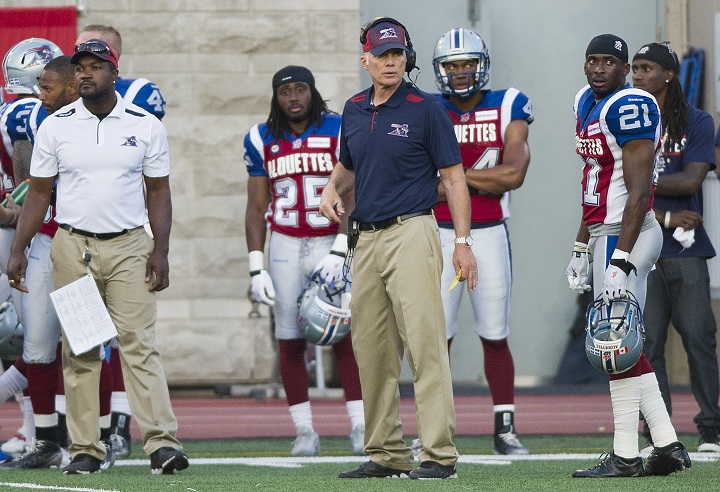 Montreal Alouettes' head coach Tom Higgins, centre, looks on from the bench during a CFL football game between the Alouettes and the Edomonton Eskimos in Montreal, Friday, August 8, 2014.