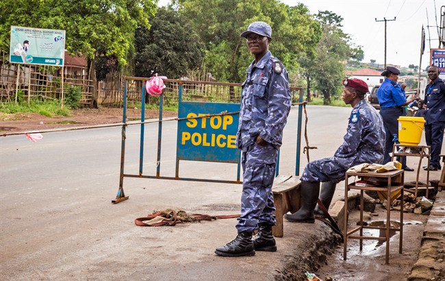 Police guard a roadblock as Sierra Leone government enforces a three day lock down on movement of all people in an attempt to fight the Ebola virus, in Freetown, Sierra Leone, Friday, Sept. 19, 2014. (AP Photo/ Michael Duff).