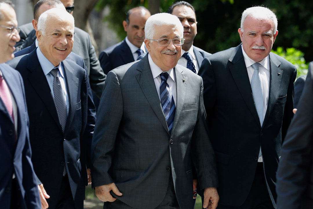 Palestinian President Mahmoud Abbas, center, arrives with the Arab League's Secretary-General Nabil Elaraby, left, and Palestinian Foreign Minister Riyad al-Maliki to attend an Arab foreign minister meeting at the Arab League headquarters in Cairo, Egypt, Sunday, Sept. 7, 2014. 