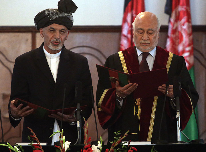 Afghan President Ashraf Ghani Ahmadzai, left, is sworn in by Chief Justice Abdul Salam Azimi, during his inauguration ceremony at the presidential palace in Kabul, Afghanistan, Monday, Sept. 29, 2014. 