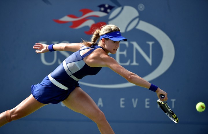 Eugenie Bouchard of Canada returns a shot to Ekaterina Makarova of Russia during their 2014 US Open women's singles match at the USTA Billie Jean King National Tennis Center.