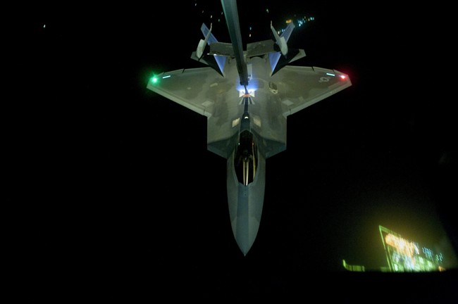 In this Friday, Sept. 26, 2014 photo, released by the U.S. Air Force, a U.S Air Force KC-10 Extender refuels an F-22 Raptor fighter aircraft prior to strike operations in Syria. 