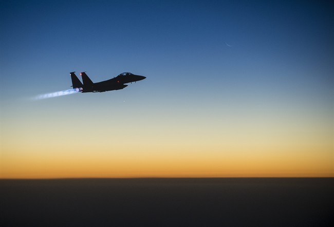 In this Tuesday, Sept. 23, 2014 photo, released by the U.S. Air Force, a U.S. F-15E Strike Eagle flies over northern Iraq, after conducting airstrikes in Syria.