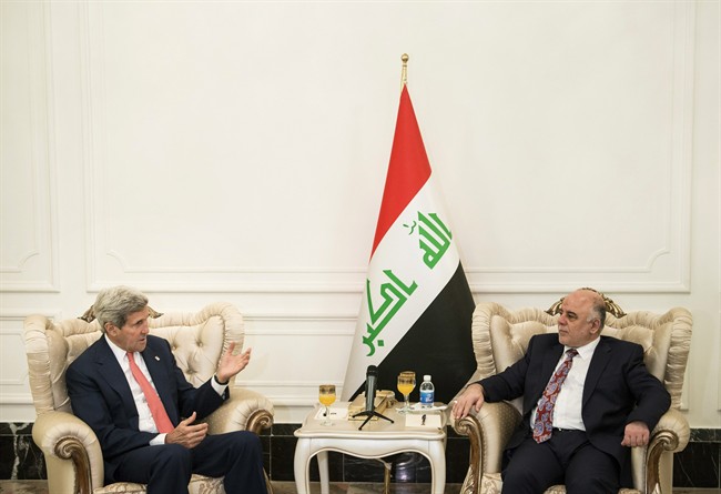 U.S. Secretary of State John Kerry, left, speaks to new Iraqi Prime Minister Haider al-Abadi during a meeting in Baghdad, Iraq, Wednesday, Sept. 10, 2014. 