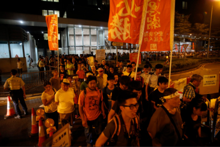 Pro-democracy activists march during a rally organized by activist group Occupy Central With Love and Peace (OCLP) in Hong Kong, China, on Sunday, Aug. 31, 2014. 