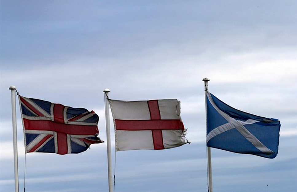 From left, the Union Jack, St George's Cross and the Saltire fly at Adderstone, England, Monday, Sept. 8, 2014. (AP Photo/Scott Heppell).