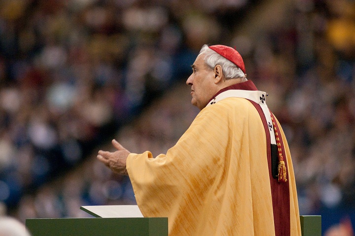 Cardinal Jean-Claude Turcotte speaking to the faithful who came to Montreal's Olympic stadium for a special mass for the canonization of Brother Andre.