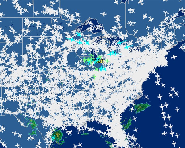 This screen shot provided by FlightAware shows airline traffic at 10:20 a.m. EDT over the United States Friday, Sept. 26, 2014, after hundreds of flights were canceled at Chicago airports, at center, following a fire at a suburban Chicago air traffic control facility. The ground stop threatened to send delays and cancellations rippling throughout the nation's air travel network, as more than 500 flights had already been canceled in Chicago and more were expected. (AP Photo/Courtesy FlightAware).