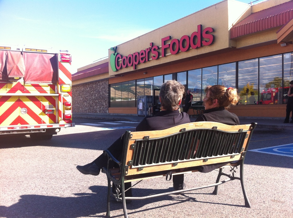 Employees wait out an emergency at Cooper's Foods on Highway 33 in Kelowna Friday afternoon. Smoke began to fill the store, forcing an evacuation. 