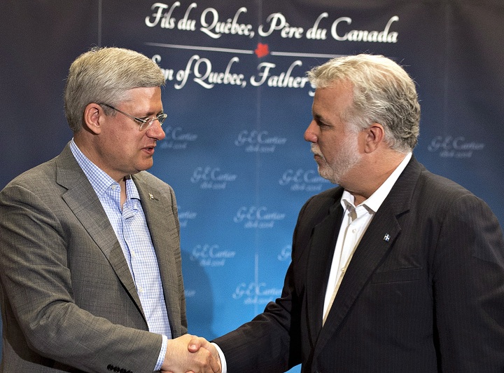Prime Minister Stephen Harper, left, and Quebec Premier Philippe Couillard shake hands at a celebration marking the 200th anniversary of George-Étienne Cartier, Saturday, September 6, 2014 in Quebec City.