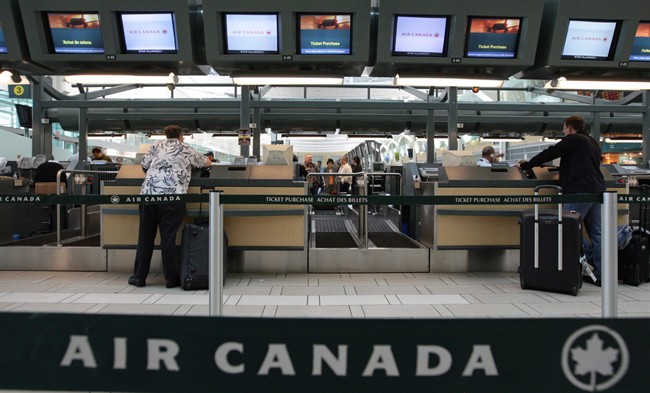 Air Canada passengers check in at the Vancouver International Airport on June 17, 2008. THE CANADIAN PRESS/Darryl Dyck