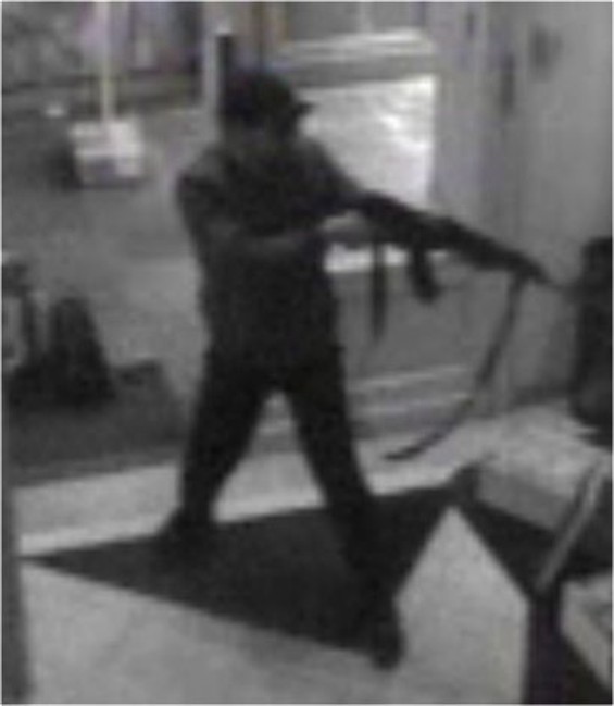 In this handout file photo distributed on Sunday, May 25, 2014 by the Belgian Federal Police, a surveillance camera shows a man shooting at the Jewish museum in Brussels, Belgium, on Saturday, May 24, 2014.