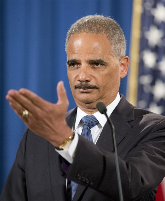 Attorney General Eric Holder gestures during a news conference at the Justice Department in Washington, Thursday, Sept. 4, 2014.
