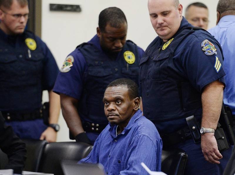 Henry McCollum is surrounded by guards as he sits in a courtroom, Tuesday, Sept. 2, 2014 in Lumberton, N.C. On Tuesday, a judge overturned the convictions of Henry McCollum, 50, and Leon Brown, 46, in the 1983 rape and murder of the 11-year-old girl, citing the new evidence that they are innocent.  (AP Photo/The News & Observer, Chuck Liddy).