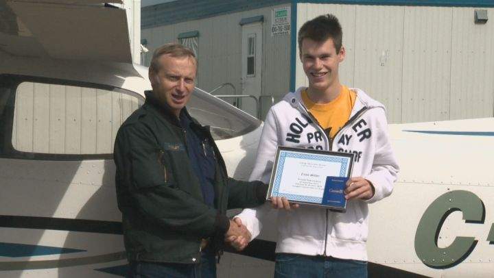 Evan Miller, 17, receives his Private Pilot Licence from his instructor, Robert Whitley, at Cooking Lake Airport Sunday, September 7, 2014.