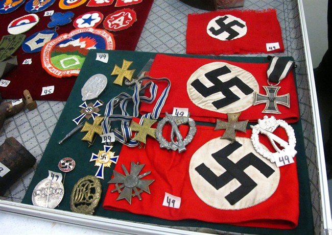 This photo dated Friday, Sept. 19, 2014, shows medals and Nazi armbands at an auction house in Anchorage, Alaska. 