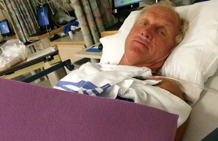 This photo provided by Greg Norman shows Norman resting in a hospital bed after a chainsaw accident. Norman posted a photo to Instagram on Sunday, Sept. 14, 2014, in which he was laying in a hospital bed with his left arm heavily bandaged. 