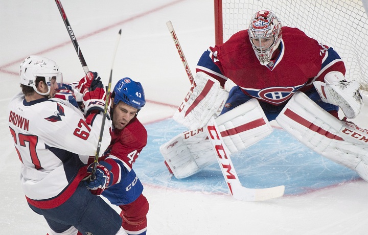 Montreal Canadiens' goaltender Carey Price (31) keeps an eye on the play as Canadiens' Mike Weaver (43) defends against Washington Capitals' Chris Brown(67) during first period NHL pre-season hockey action in Montreal, Sunday, September 28, 2014.