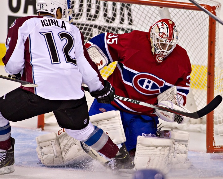 Montreal Canadiens goalie Dustin Tokarski stops the puck against Colorado Avalanche Jarome Iginla during the first period action in NHL exhibition game Friday, September 26, 2014 at Quebec Colisee in Quebec City.