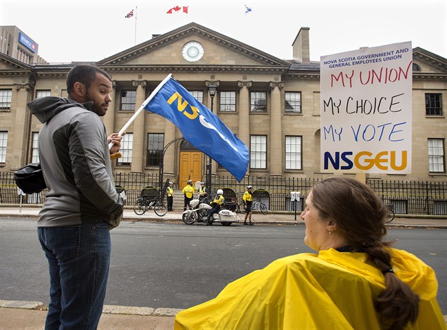 Protesters wait outside the Nova Scotia legislature in Halifax on Sept. 30, 2014. 