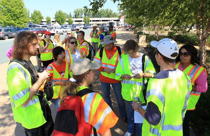 Volunteers talk with their team leader outside the John Paul Jones Arena before participating in a massive search effort by the community for missing University of Virginia student Hannah Graham, Saturday, Sept. 20, 2014, in Charlottesville, Va.