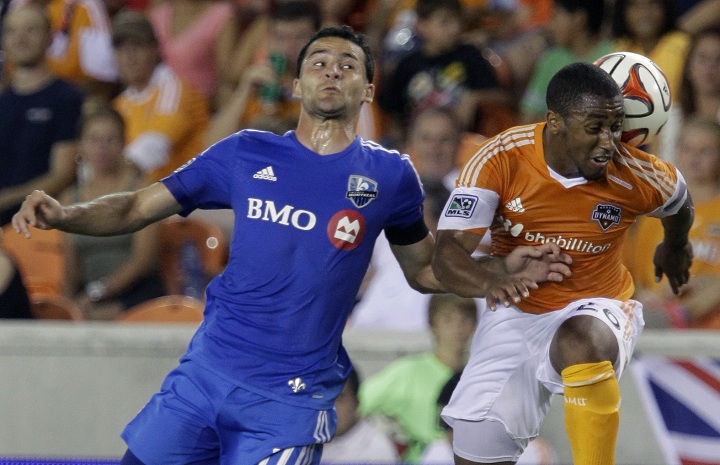 Montreal Impact Dilly Duka, left, and Houston Dynamo Coery Ashe, right, go up for a header during the first half of a soccer game at BBV Compass Stadium Saturday, Sept. 6, 2014, in Houston.