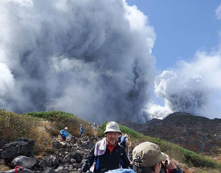 In this photo taken by an anonymous climber and was offered to Kyodo News, climbers descend Mt. Ontake to flee as the volcanic moutain erupts in central Japan, Saturday, Sept. 27, 2014. 