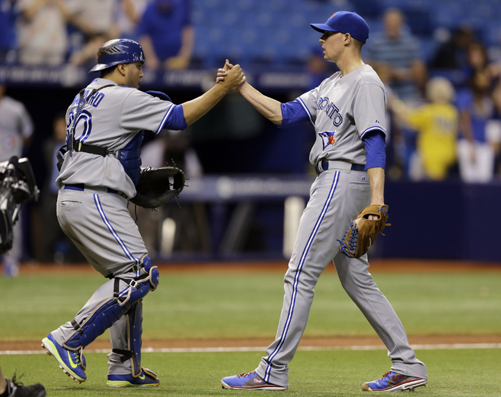 Toronto Blue Jays relief pitcher Aaron Sanchez, right, shakes hands with catcher Dioner Navarro after closing out the Tampa Bay Rays during the ninth inning of a baseball game Wednesday, Sept. 3, 2014, in St. Petersburg, Fla. 
