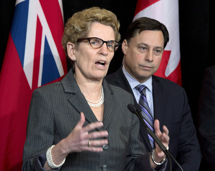 Ontario Premier Kathleen Wynne (left) speaks and Minister of Training, Colleges and Universities Brad Duguid listens after meeting with education representatives at Queen's Park in Toronto Thursday, March 27, 2014.