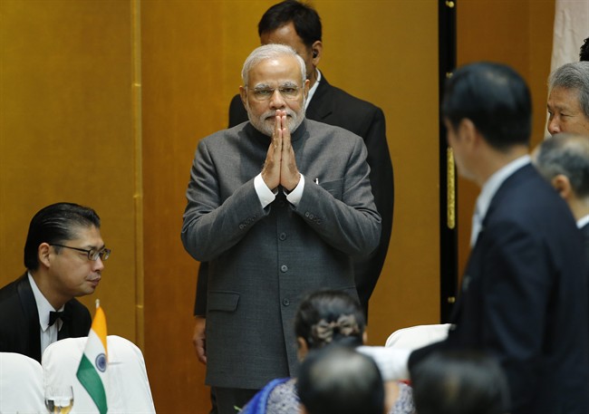 Indian Prime Minister Narendra Modi greets business leaders upon his arrival at the hall at the Japan Business Federation for luncheon in Tokyo Monday, Sept. 1, 2014. 